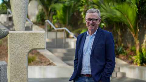 Peter Shepherd stands in a garden at the University of Auckland.