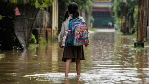 Child walking through flood area