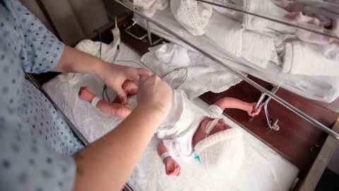 Premature baby and mother in hospital
