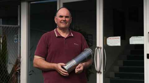 Associate Professor Ashton Partridge holds the first prototype developed by his team. Photo: William Chea
