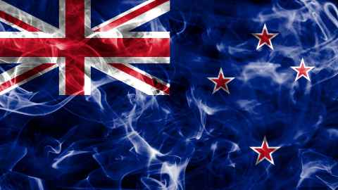 Smoke haze in front of a nz flag