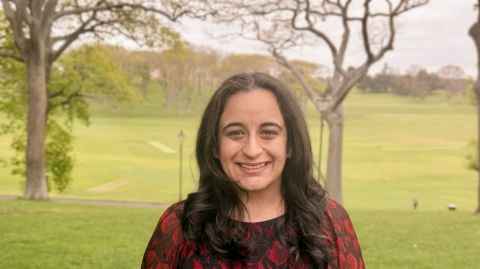Dr Simerdeep Dhillon stands in a park.