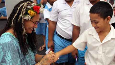 Image of Selina Tusitala Marsh and a student from Nauti Primary