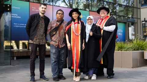 Annisa Hasanah with her family and supervisor on graduation day.