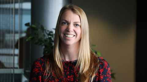 Photo of a woman with blond hair smiling at the camera. 