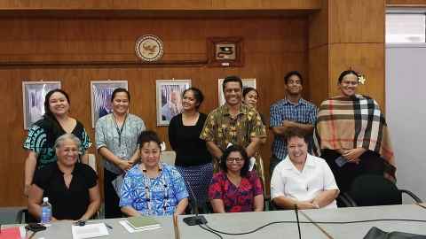 Image of Dr Sarah McRobie with NUS staff and students