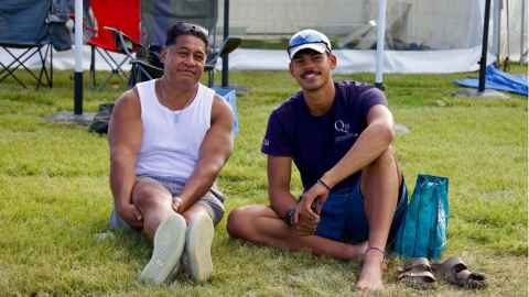 Image of Arie Rasmussen Magasiva with father Stevan sitting on the grass.