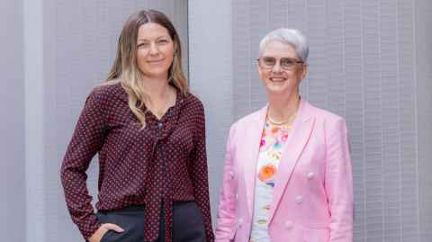 The two women stand together