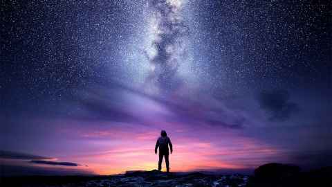 A person looking up at the night sky.