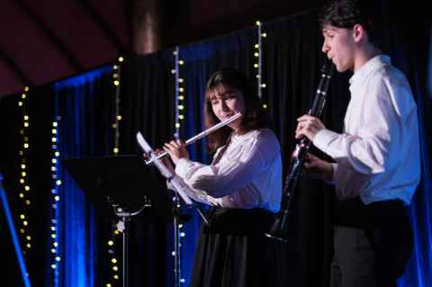 Two students playing a flute and clarinet at the Residential Excellence Awards