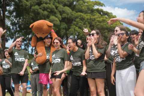 Large group of Grafton Hall residents chanting excitedly in the Auckland Domain. 