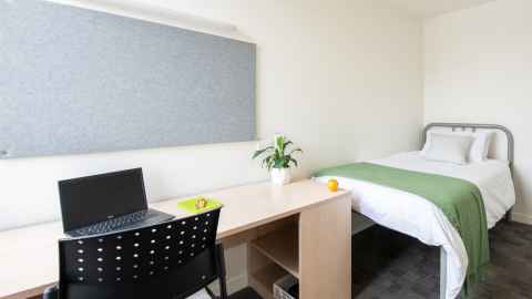 Room in Carlaw Park Student Village with a bed and a desk.