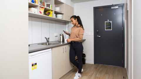 A resident using the kitchen in their room