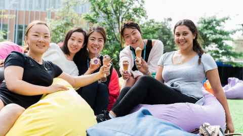 Group of five people on bean bags eating ice cream