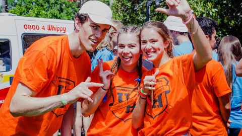 Three students in orange University Hall Towers shirts during Halls Day Out 