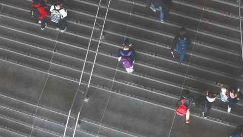 Overhead view of a set of stairs with people walking on them
