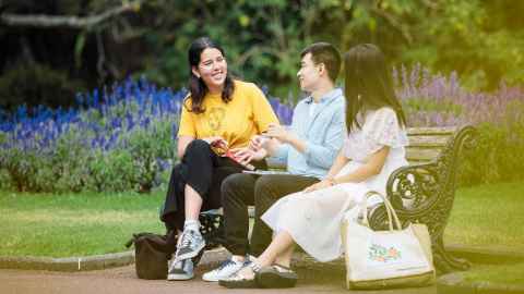 Three people sitting on a bench