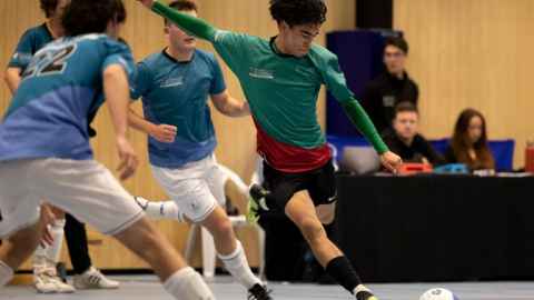 Student playing interfaculty futsal
