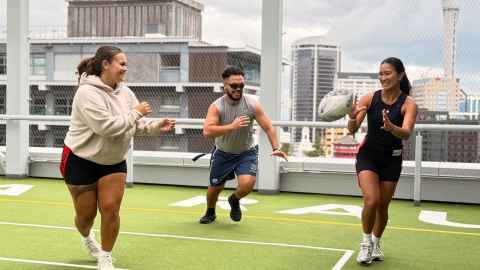 Three students playing Rippa Rugby