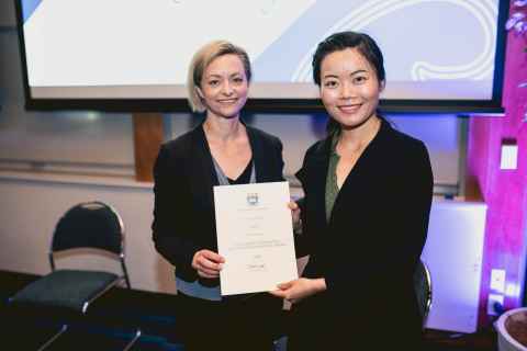 Two women holding a certificate.