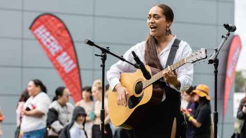 Student performing with guitar