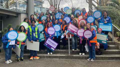 Large group of students with signage for Open Day