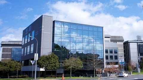 Several large modern buildings and a small courtyard.