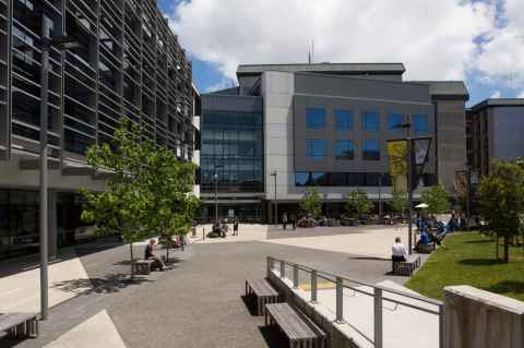 Buildings around a courtyard and grassed area.