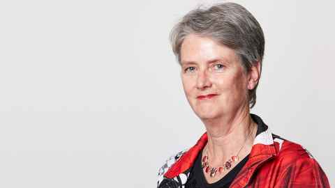 A grey-haired woman wearing red.