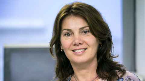 A smiling dark-haired woman.