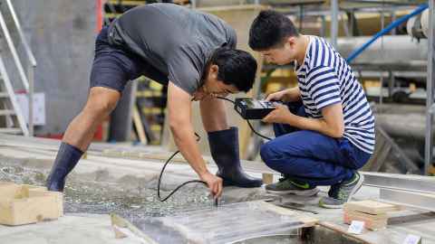 Two men doing practical engineering work.