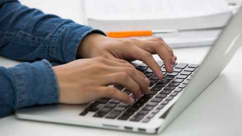 Hands typing on keyboard