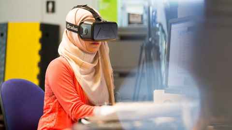 Computer science student wearing VR headset