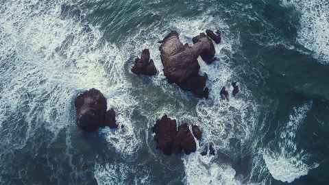 Heavy waves crashing on rocks from above
