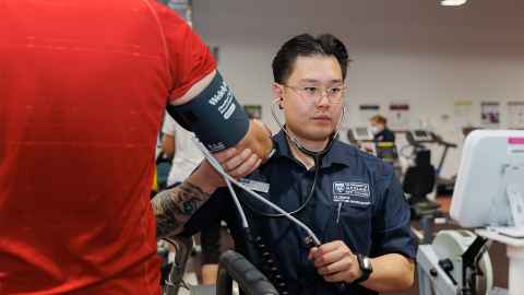 Exercise science student checking blood pressure. 