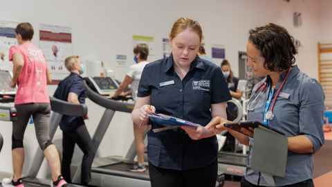 Exercise science student working with teacher.