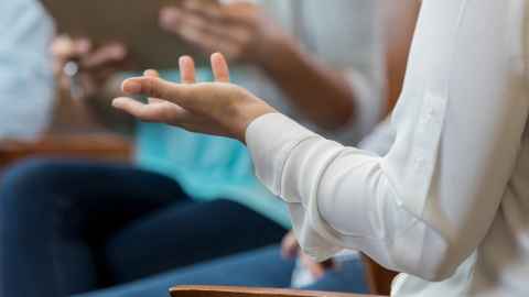Close up of hands in a meeting.
