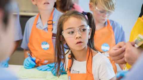 Young girl listening to instructions at BASF Kids Lab 2017
