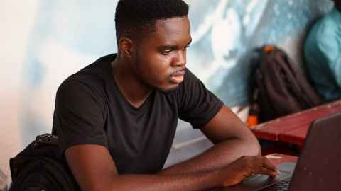 Student sitting at a laptop