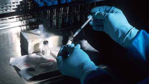 Close up of forensic scientist conducting an experiment in a lab