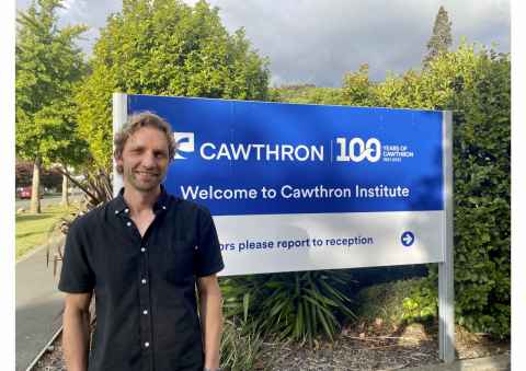 An image of Molecular scientist Oliver Laroche next to the Cawthron sign. 