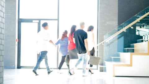 Office workers walking into building in Auckland New Zealand