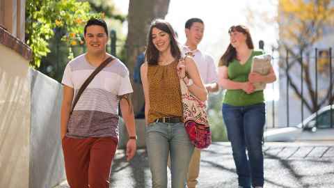 Five students standing together in front of the John Hood Plaza