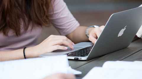Person using laptop.
