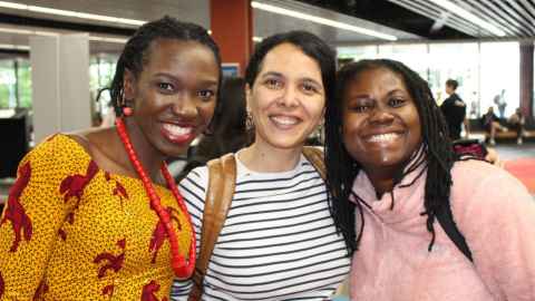 Three doctoral candidates smiling and posing for a photo at the University of Auckland's annual SGS Research Showcase.
