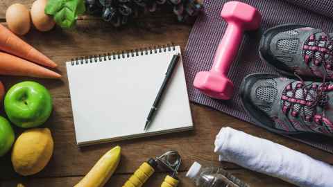 Items like fruit, vegetables, a journal, and sporting equipment symbolise a healthy lifestyle for doctoral candidates at the University of Auckland.