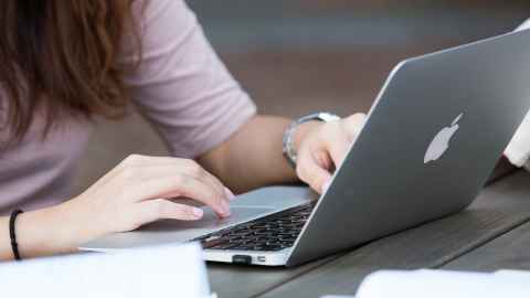 person typing on laptop