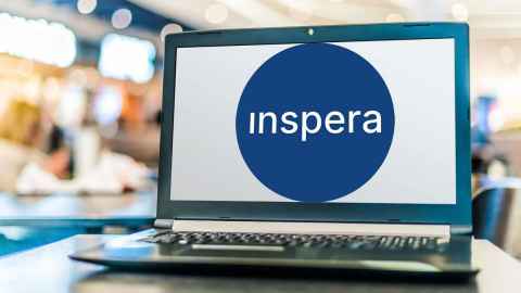 Laptop open with a large inspera logo showing