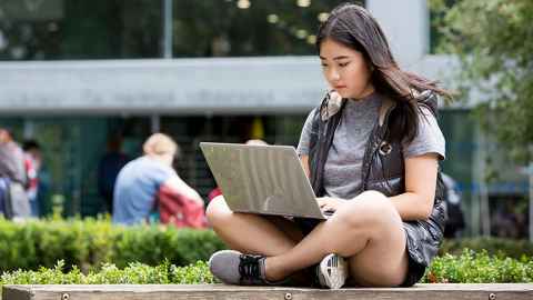 Girl working outside on laptop