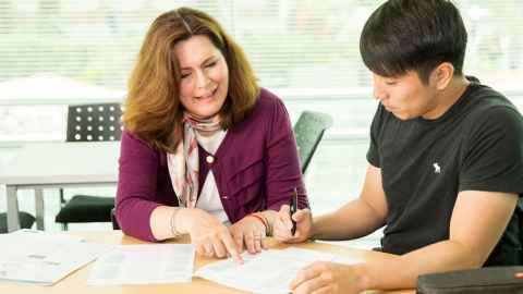 English Language Enrichment student receiving one-on-one advice